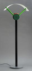 A tall Y-shaped lamp. White circular base, long black stand, green top, semi-oval white lampshade